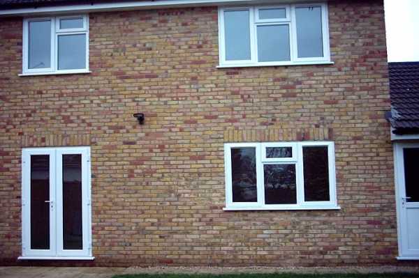 This shows the rear of the property with french windows fron living room leading onto landscaped gardens.